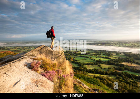 A rambler looking across the Cheshire plains with cloud inversion from Cloudside near Congleton, Cheshire. Stock Photo