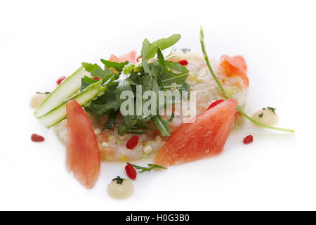 Tartare of scallops with tomato and mango juice and yuzu on white background Stock Photo