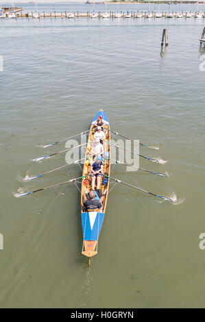 Venice, Italy - May 20, 2016: Female crew is training on a rowing boat in Venice. Stock Photo