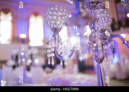 Beautiful restaurant interior table decoration for wedding. Flower . White orchids in vases. luxury candleholders Stock Photo