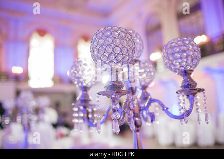 Beautiful restaurant interior table decoration for wedding. Flower . White orchids in vases. luxury candleholders Stock Photo