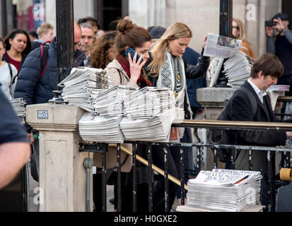 commuters stacks Evening Standard newspapers home Stock Photo
