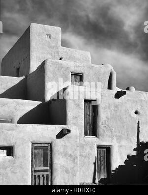 An B&W 8x10 vertical image of an adobe stacked house at Taos Pueblo In New Mexico.Taos is a UNESCO World Heritage Site Stock Photo