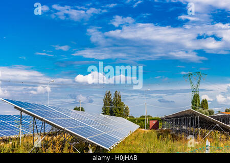 photovoltaic panels under cloudy bright blue sky Stock Photo
