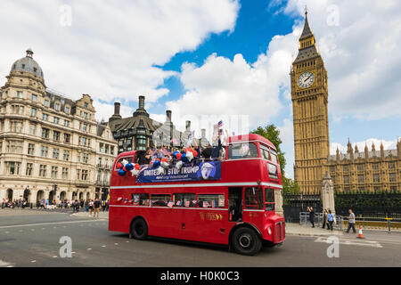 London, UK. 21st Sep, 2016. London, September 21st 2016. A 'Stop Trump' open topped red London double-decker bus passes the Houses of Parliament and Big Ben in London in a bid to encourage US expats to register to vote in the Presidential election, expecting the majority of them to be more inclined to support Hilary Clinton. Credit:  Paul Davey/Alamy Live News Stock Photo