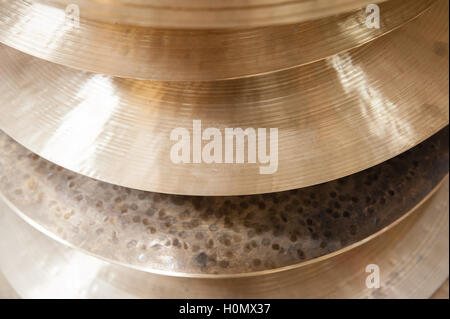 Pile of many different surface crash cymbal drum plate part detail close up Stock Photo