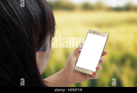 Smart phone in woman hands. Isometric perspective behind the head. Stock Photo