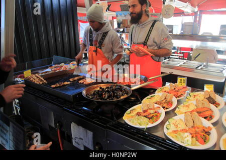 Street stall restaurant cooking fish meals in Torget market, Bergen, Norway Stock Photo