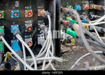 the electrical power cables connected to a temporary outdoors distribution station Stock Photo