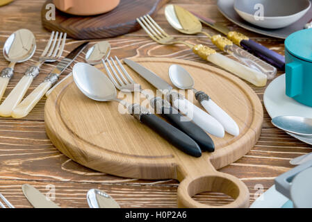 the Fork and Spoon and Table Knife on the wooden Cutting board Stock Photo