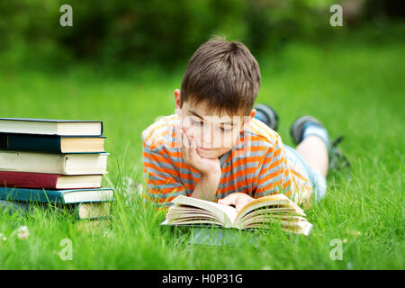 seven years old child reading a book Stock Photo