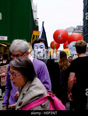Protestor wearing Guy Fawkes mask at anti-austerity protest in London, England
