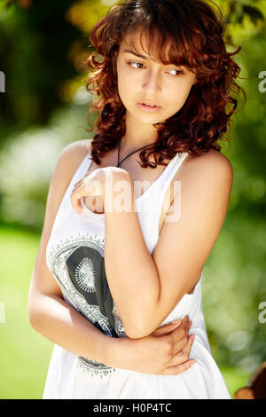 Thoughtful looking girl outdoors Stock Photo