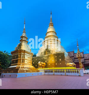 Dusk View of the golden stupa of Wat Phra Singh temple, the most revered temple in Chiang Mai, Thailand.