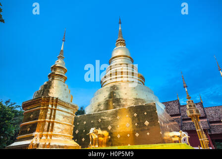Dusk View of the golden stupa of Wat Phra Singh temple, the most revered temple in Chiang Mai, Thailand.