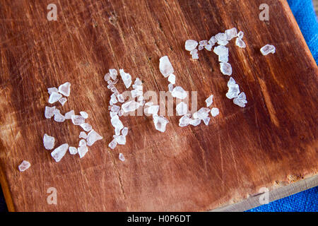 Sea salt letters over rustic wooden background close up Stock Photo