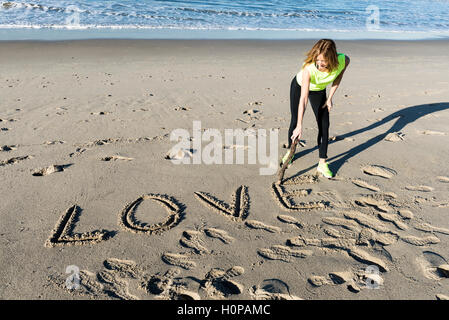Young adult woman with word Love on her body Stock Photo - Alamy