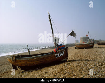 Traditional wooden clinker-built fishing boats and Georgian Martello towers on Fisherman's Beach, Hythe, Kent, England. 1992. Stock Photo