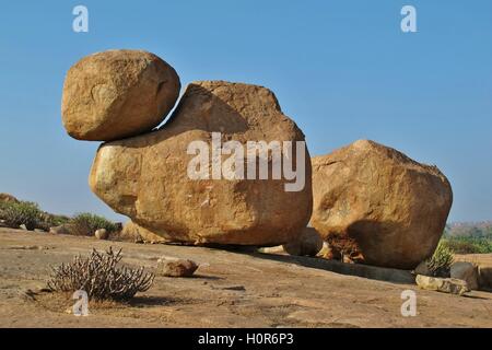 Big granite boulder with smaller boulder on top. Popular boulder for rock climbing. Sculpture shaped by mother nature. Stock Photo