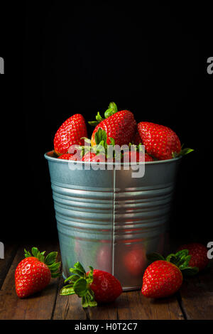Bucket with fresh strawberries on a black background Stock Photo - Alamy