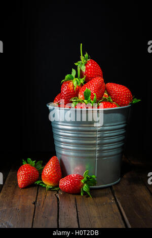 Bucket with fresh strawberries on a black background Stock Photo - Alamy