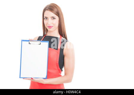 Pretty supermarket employee presenting blank clipboard with advertising area isolated on white background Stock Photo