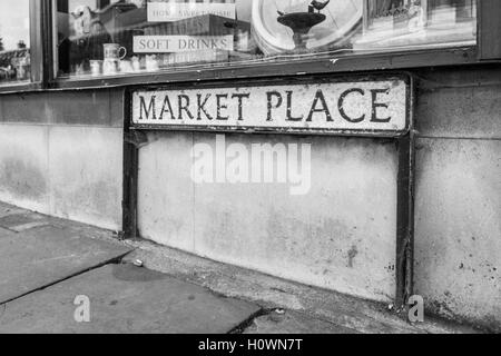 Aged street sign showing the name 'Market Place' on a street corner in Burton, United Kingdom Stock Photo