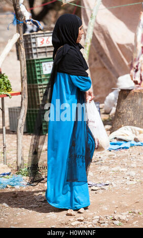 Atlas Mountains, Morocco.  Woman Walking in Market in Berber Village near Dades Gorge. Stock Photo