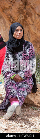 Atlas Mountains, Morocco.  Berber Woman Sitting, Observing Market Scene in Village near Dades Gorge. Stock Photo