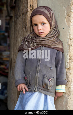 Dades Gorge, Morocco.  Young Berber Girl Standing by her Doorway. Stock Photo