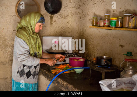 Dades Gorge, Morocco.  Middle-aged Berber Woman Preparing Dinner in her Kitchen. Stock Photo