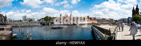 AMSTERDAM - JULY 10, 2016: Big panoramic of Central Station and canal, July 10, 2016 in Amsterdam. Central Station Netherlands Stock Photo