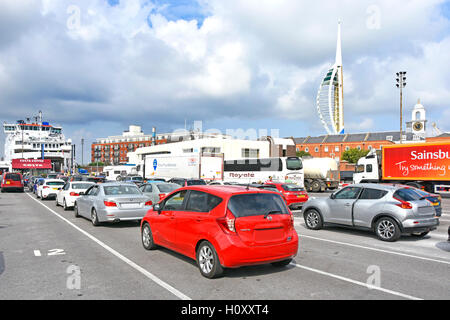 Cars lorries & coach queuing to board Wightlink summer ferry crossing Solent to Fishbourne on the Isle of Wight England UK some obscured number plates Stock Photo