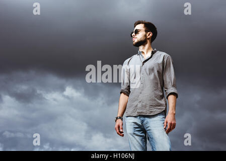 Fashion man posing on the sky bacdrop Stock Photo
