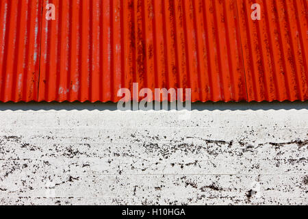 red painted corrugated metal roof on a farm outbuilding in Iceland Stock Photo