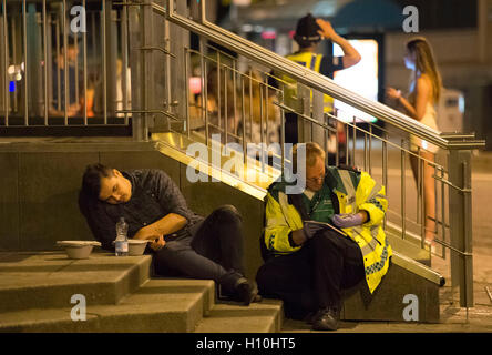 St. John Ambulance crew help a drunk man outside a nightclub during Freshers week in Cardiff, South Wales. Stock Photo