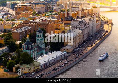Moscow city shot from above with church river and a boat sailing in Moscow. Traveling and flying over Moscow, Russia. Sunset cit Stock Photo