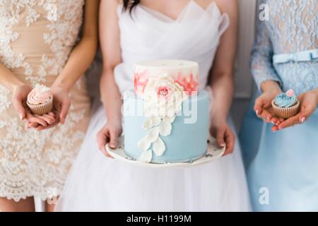 Bride holding a beautiful wedding cake Stock Photo