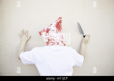 Hooded Murderer blood with knives, halloween Stock Photo