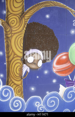 Black girl curls drawn on wall decoration Stock Photo