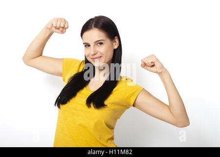 Active muscular girl looking at one of her arms in sports club Stock Photo  - Alamy