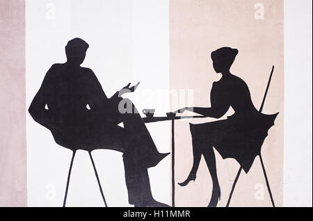 Friends drinking coffee in a bar table, silhouette Stock Photo