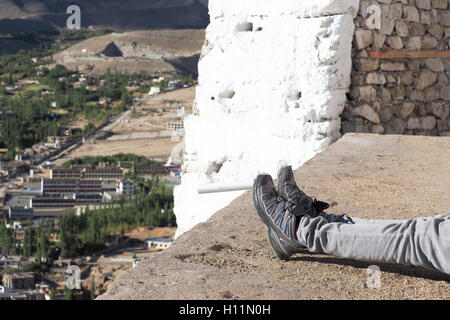 Hiker's boots relaxing and resting his feet on high mountain trekking scene and adventure. Stock Photo