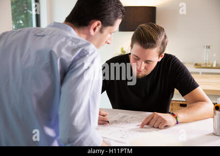 Two male office workers sharing ideas in a modern office Stock Photo