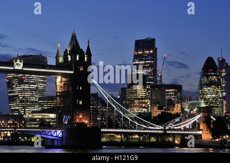 The City of London UK and Tower Bridge at dusk from the south bank of the Thames Stock Photo