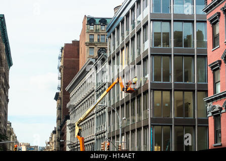 Construction worker on a cherry picker working on a new building in Lower Manhattan Stock Photo