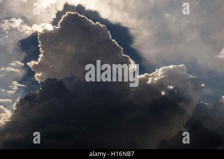 Thunderclouds, Altocumulus, sun behind grey clouds Stock Photo