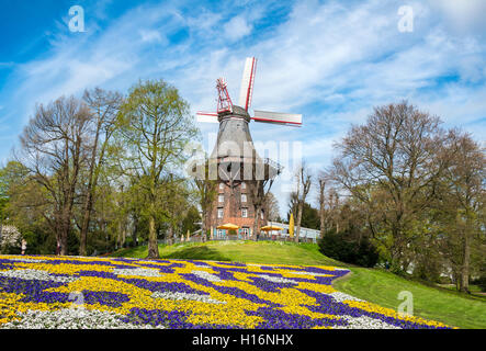 Windmill with colorful flowerbeds, Am Wall Windmill or Herdentorsmühle in the ramparts, spring, mill on the wall, Bremen Stock Photo