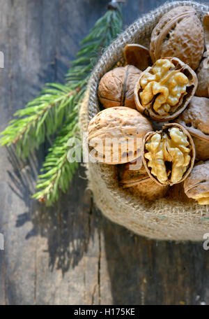 walnuts in a bag on a wooden background Stock Photo