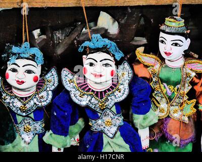 Close up of three brightly coloured hand-made traditional Burmese string puppets Stock Photo